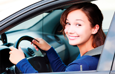 image of a woman smile while driving